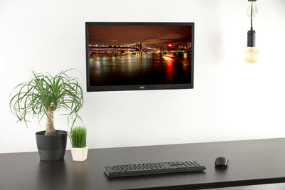 Pneumatic monitor wall mount for an office or at-home workstation.