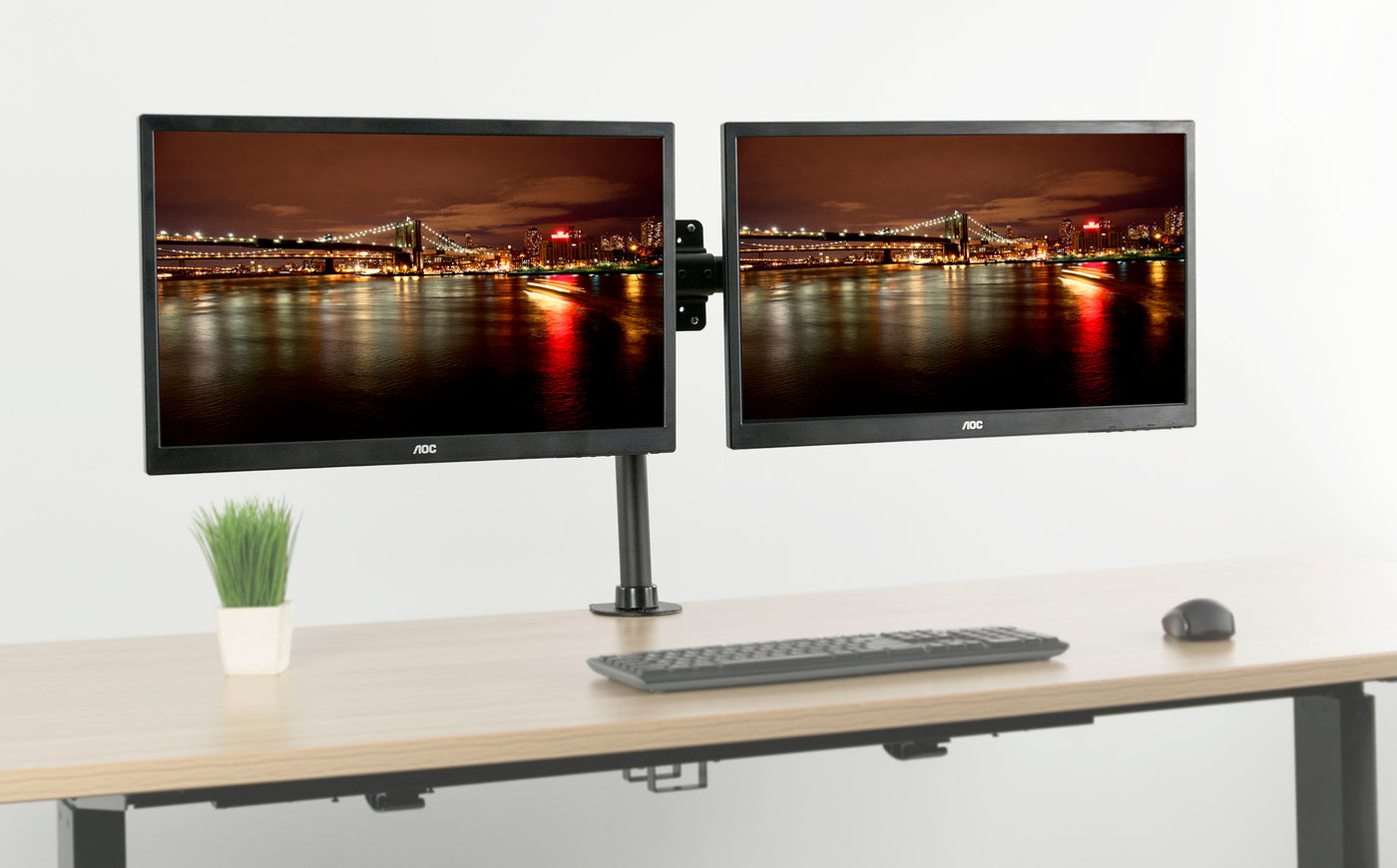 Dual adapter bracket for a dual screen set up in a workspace.