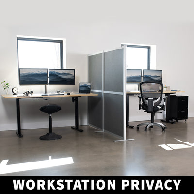 Side by side workstations with a privacy wall panel running vertically between.
