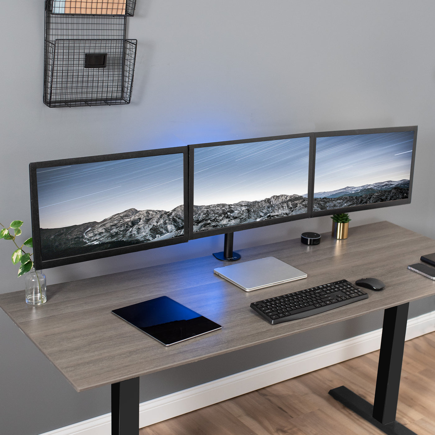 Sturdy height adjustable triple monitor desk mount.